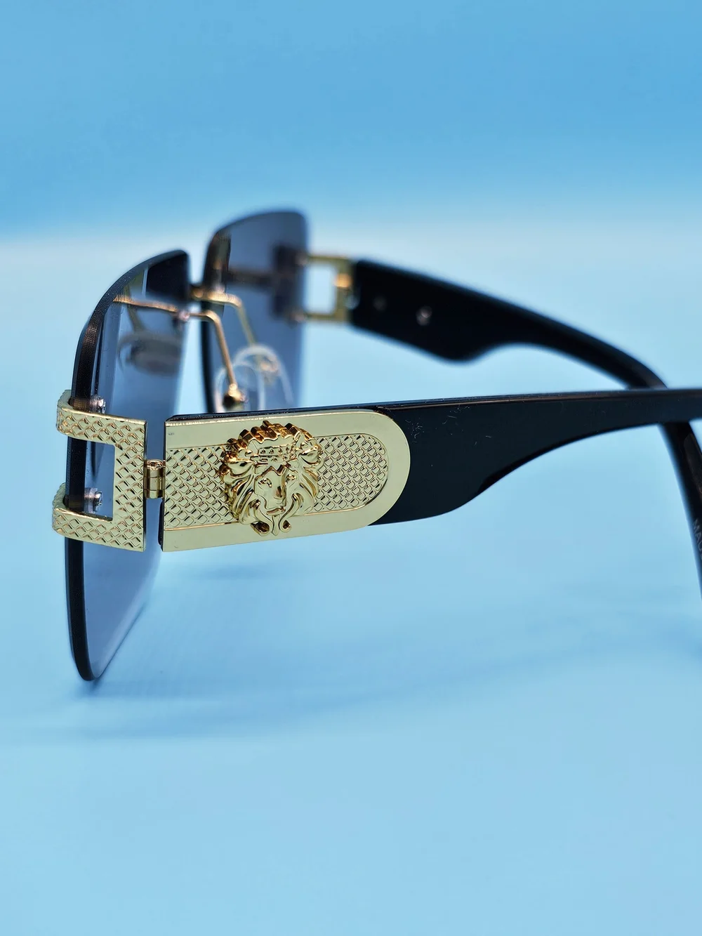 Gold-Trim Black Sunglasses with Dark Lenses